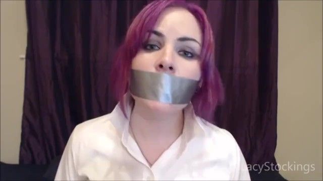 Purple haired gal talking with her throat taped shut